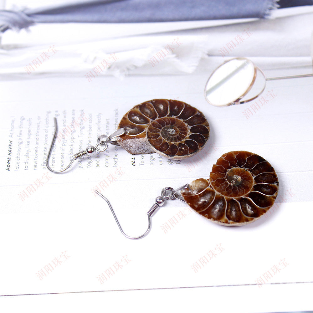 RYS A pair of handmade earrings carved from natural shell fossils